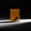 Orange supplement package with 'UP' branding on a black background