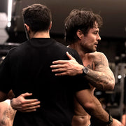 Two men embracing each other in a close-up shot.