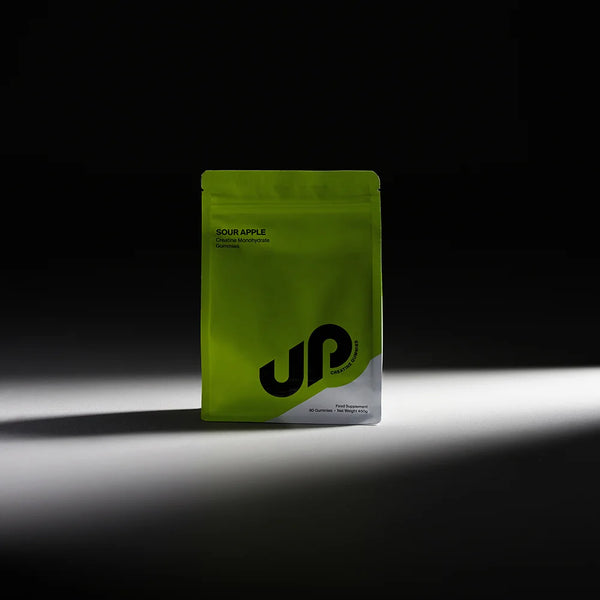 Green supplement package with 'UP' branding on a black background