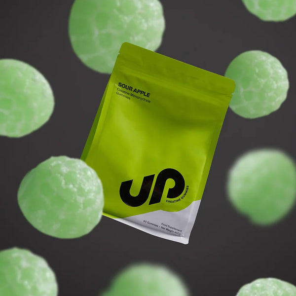 Green supplement package with UP Nutrition logo on a dark background with green spherical objects.