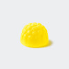 Yellow textured object on a light gray background